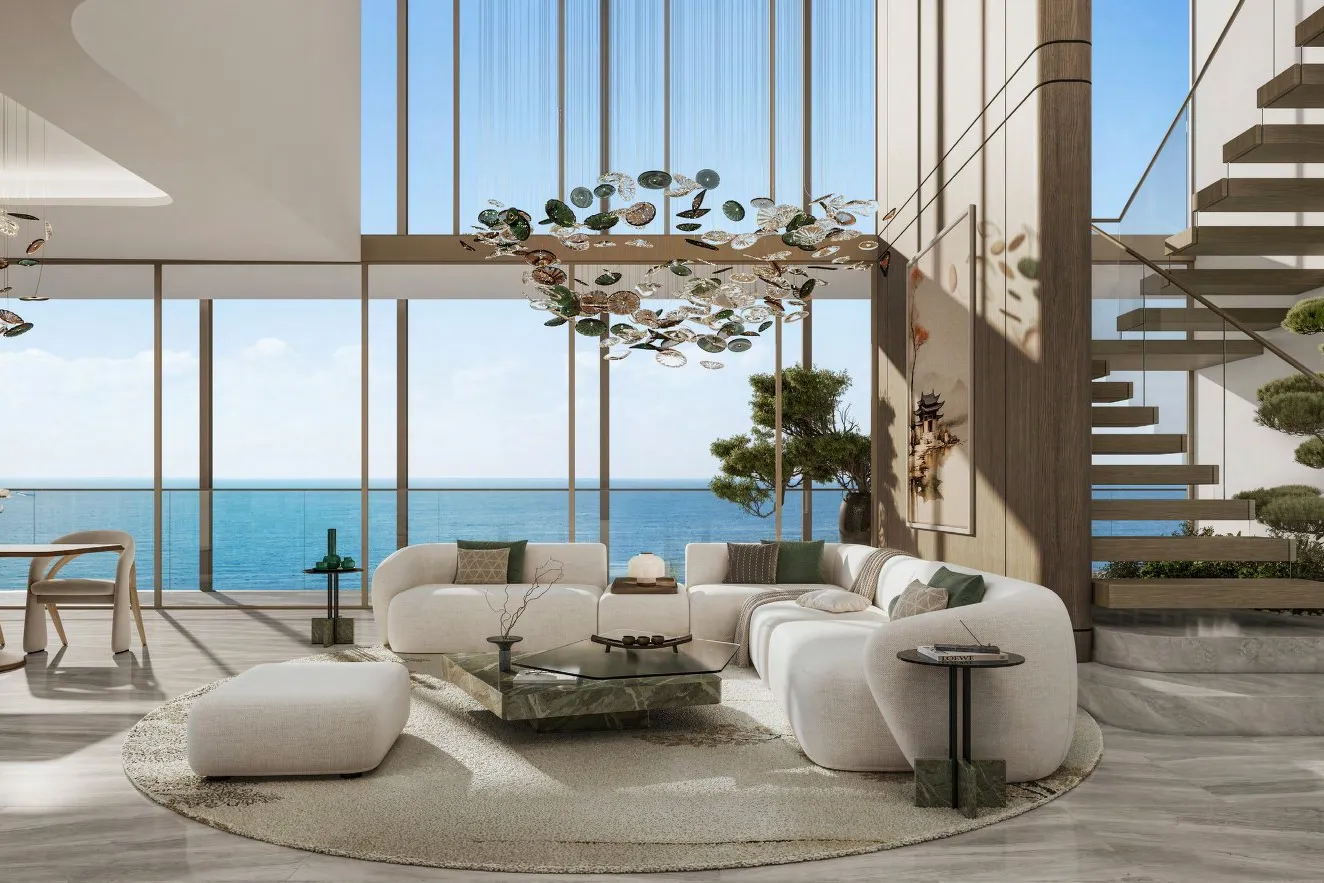 Double-height living room facing the sea with a floating timber staircase