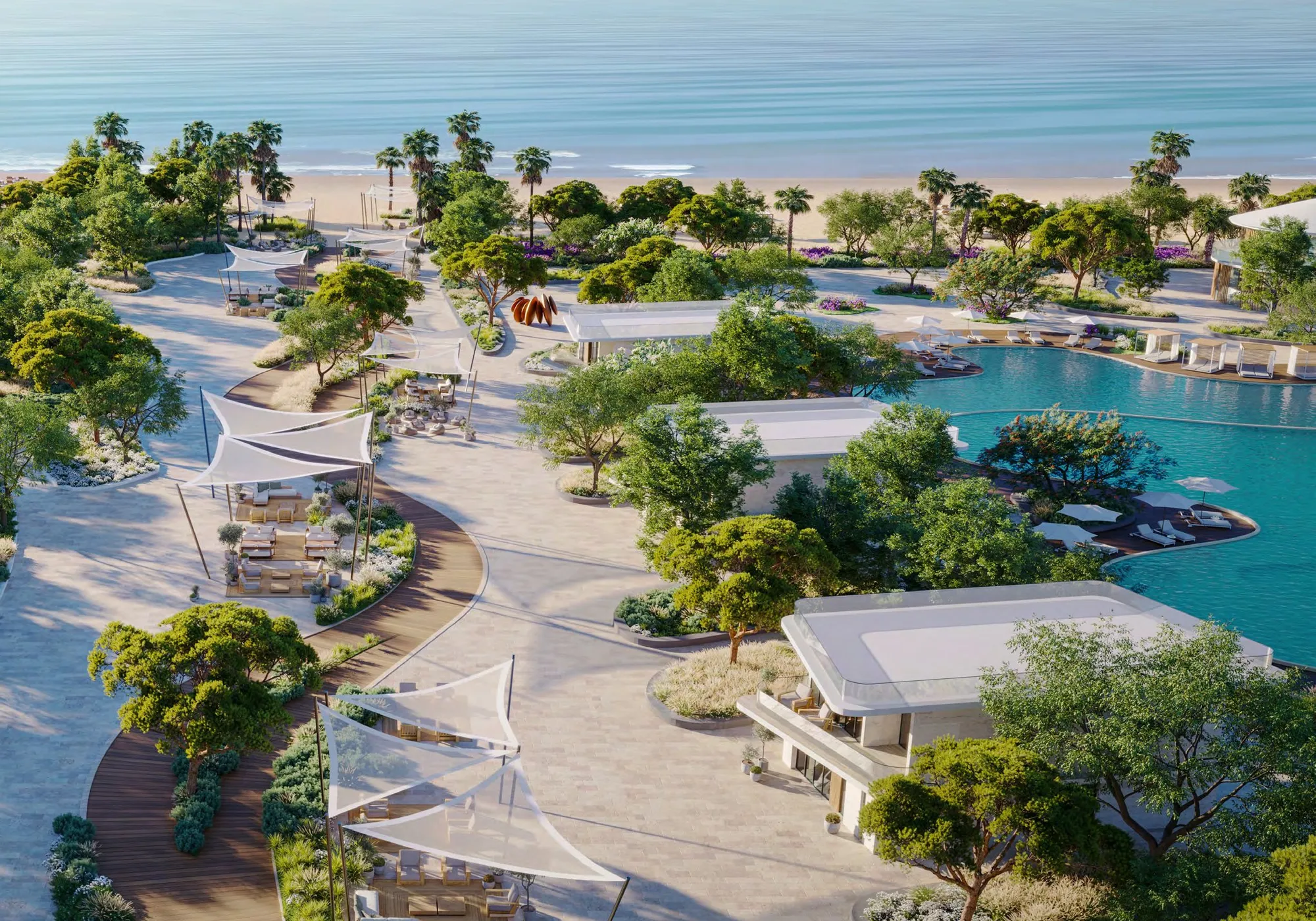 Aerial of Siora's beachfront gardens, shaded walkways and pool by the sea